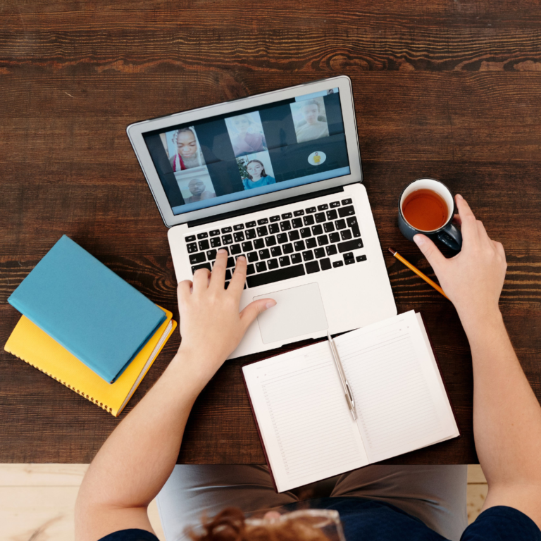 Person looking at computer during a coaching and personal development group session