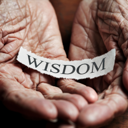 hands of old woman with words wisdom for a life coach