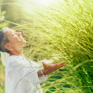 Woman with hands outstretched in grass